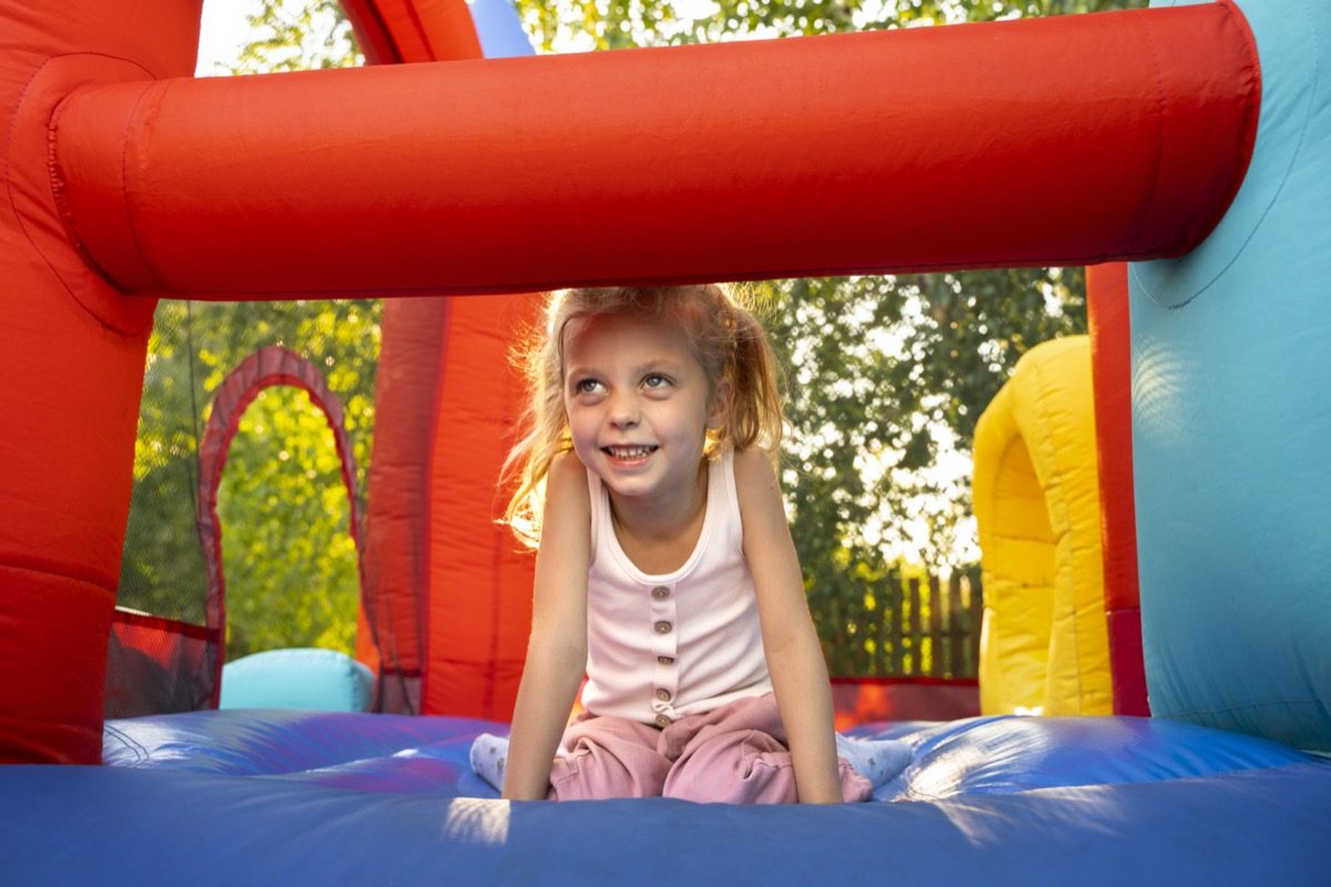 Supervised Kids Playing on a Securely Anchored Bouncy Castle Supervised Kids Playing on a Securely Anchored Bouncy Castle